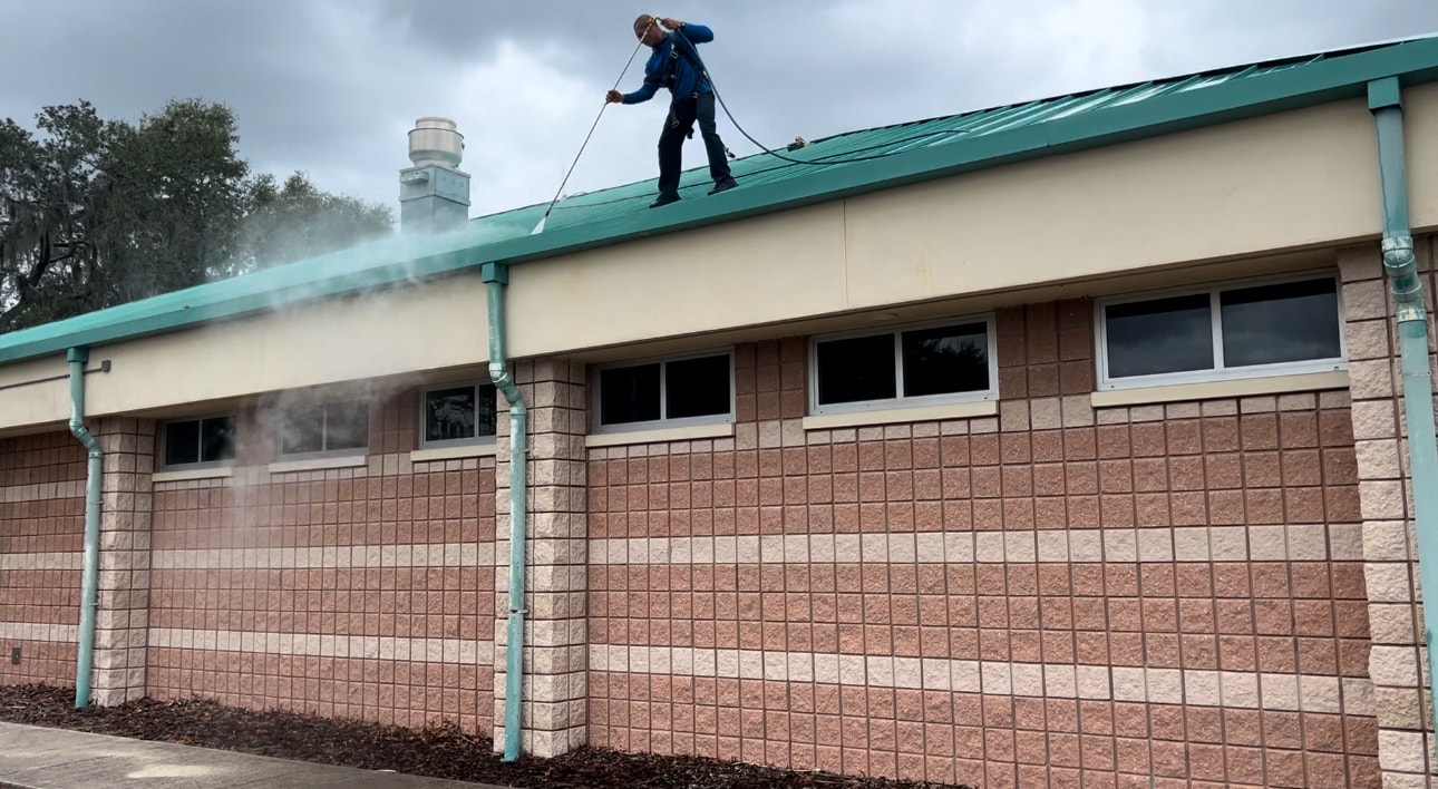 Commercial building being pressure washed